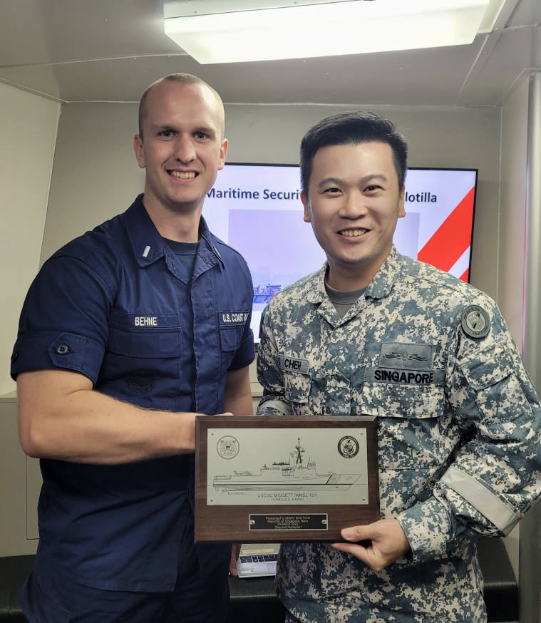 Lieutenant Junior Grade Behne (left) from USCGC Midgett presenting a token of appreciation to Commanding Officer MSRV Bastion MAJ Cheh Guo Jun (right).