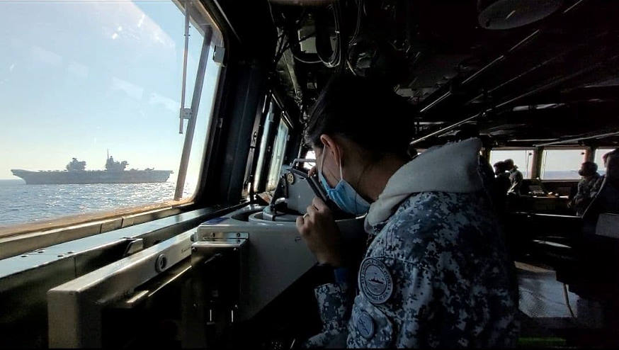 Crew member on board RSS Formidable taking bearing from HMS Queen Elizabeth during the PASSEX.