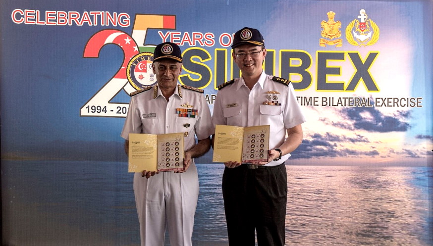 Then-RSN Chief of Navy, RADM Lew Chuen Hong (right) and IN Chief of Naval Staff, Admiral Sunil Lanba pose with the SIMBEX Silver Jubilee Commemorative Stamps that were specially created for SIMBEX 2018.