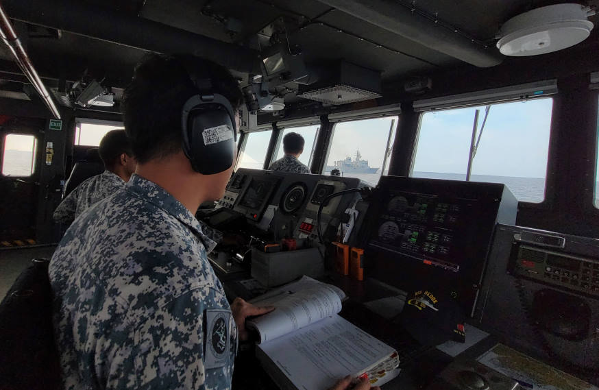 RSS Bedok's Communications Systems Operator promulgating and interpreting all signals sent by their Japanese counterpart during a communication serial.