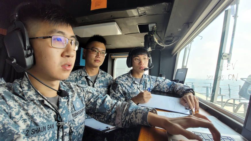 Personnel from RSS Endeavour listening to a radio message sent by their Indonesian counterpart during a communications drill.