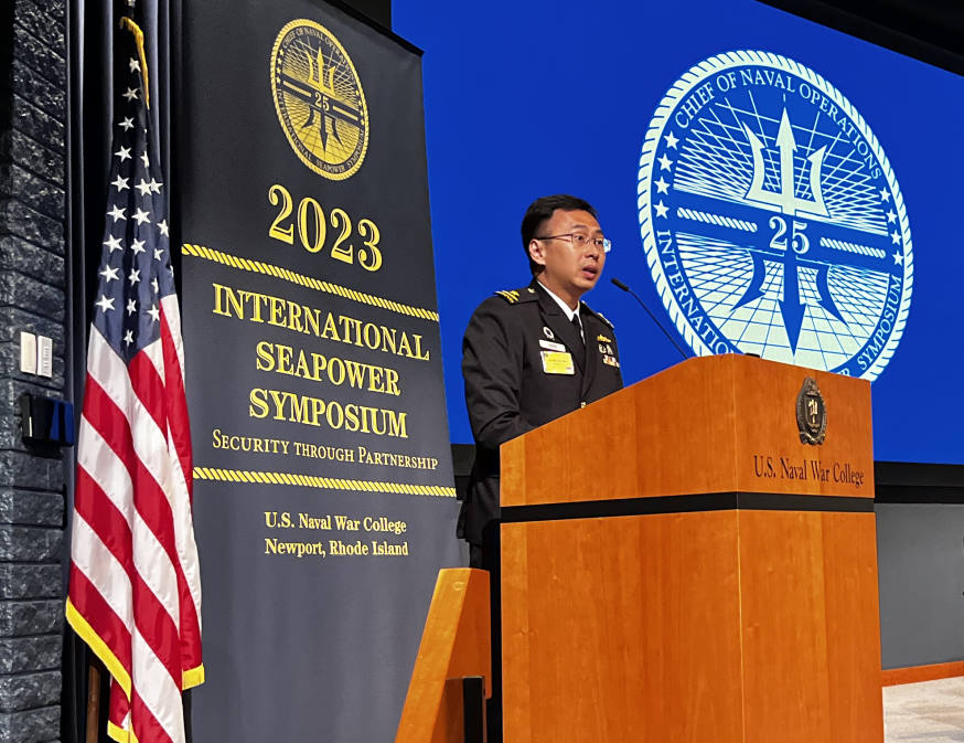 RADM Wat delivering a speech