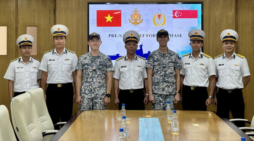 Officers from both ships coming together to discuss the PASSEX serials during the port call at Cam Rahn Bay.